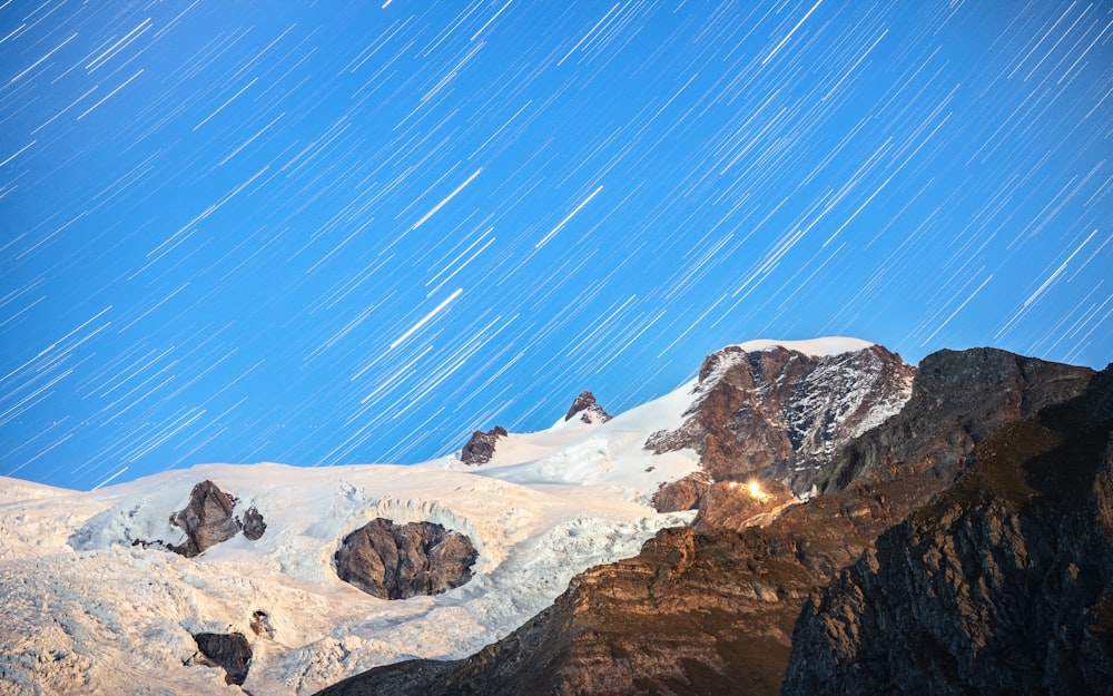 a snow covered mountain with stars in the sky