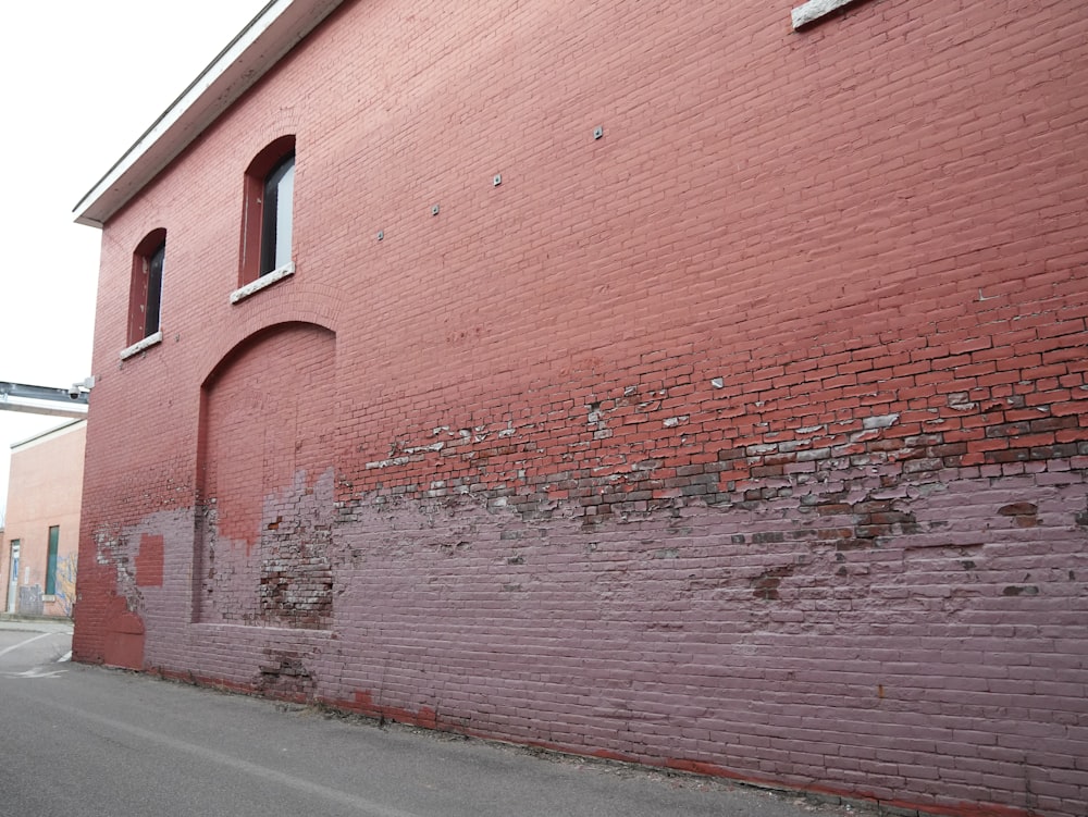 a red brick building with a red fire hydrant in front of it