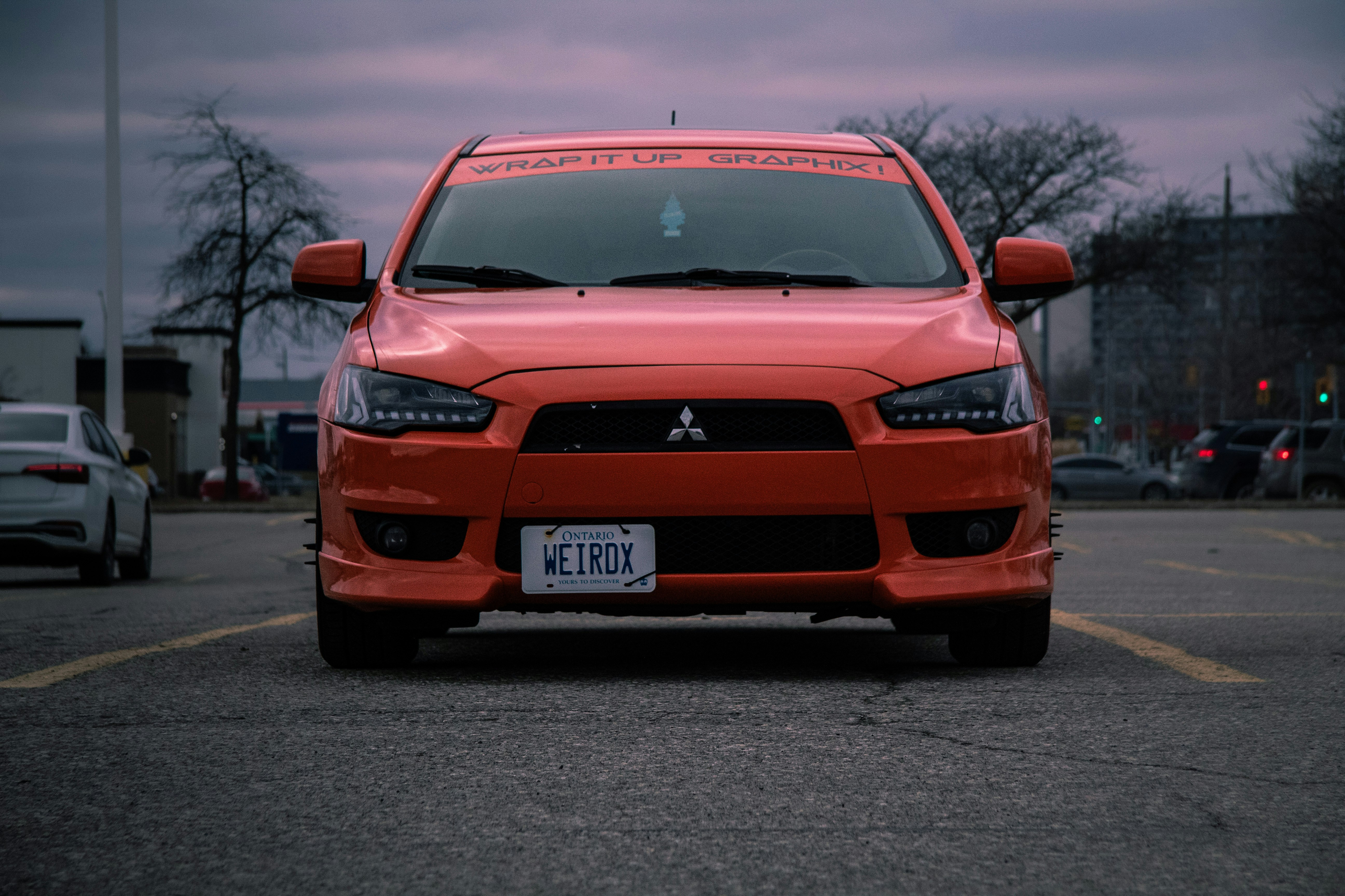 a red car parked in a parking lot