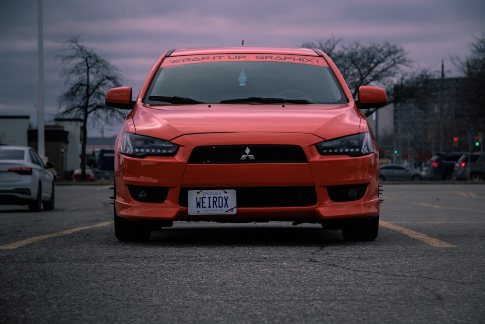 a red car parked in a parking lot