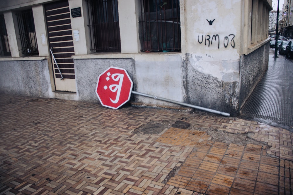 a red stop sign sitting on the side of a building