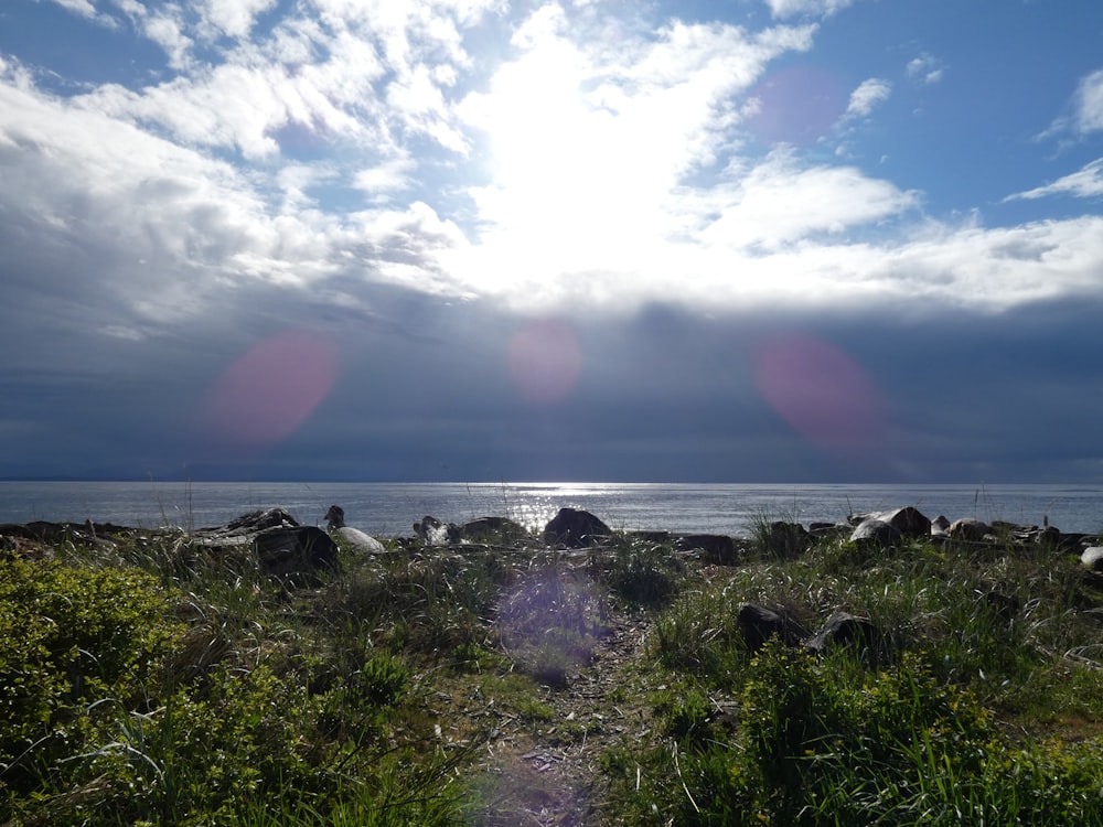 the sun shines through the clouds over the ocean