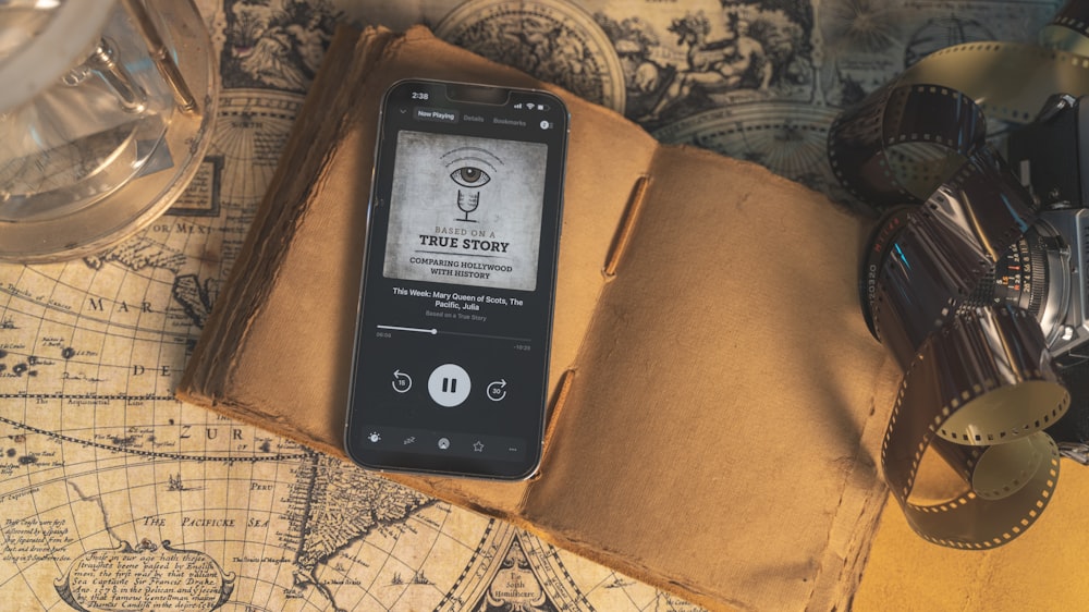 a smart phone sitting on top of a book