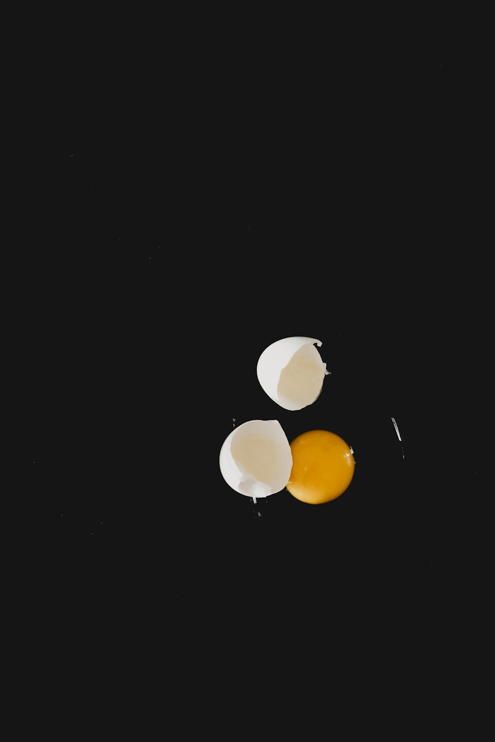 a couple of eggs sitting on top of a black surface