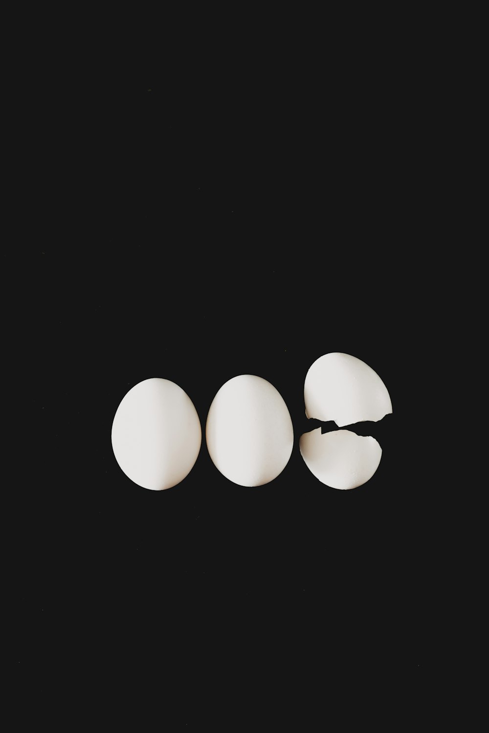 a group of three eggs sitting next to each other
