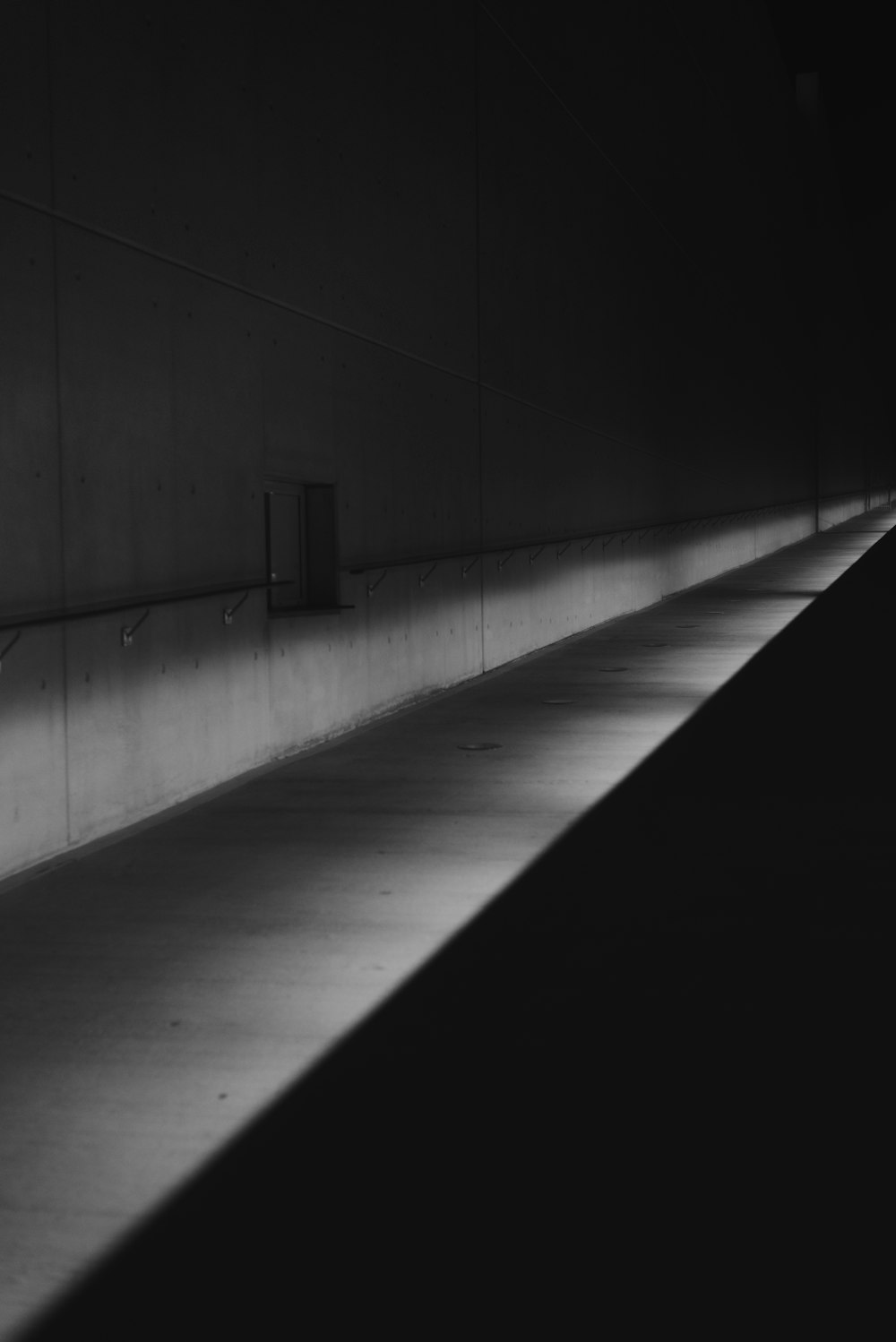 a man riding a skateboard down a tunnel