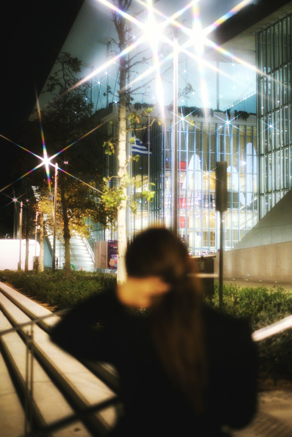 a woman walking down a street at night