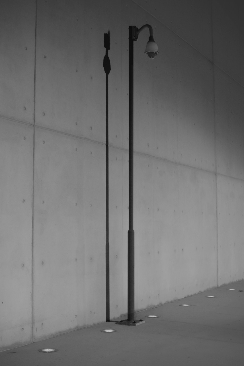 a black and white photo of a street light