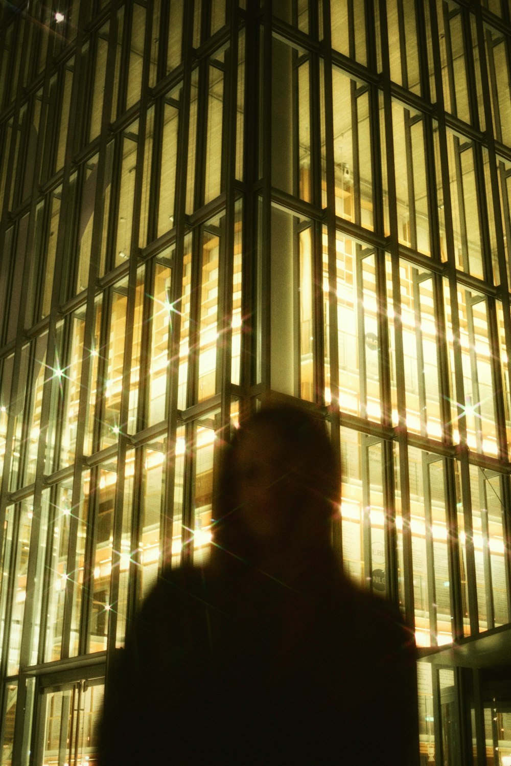 a person standing in front of a tall building