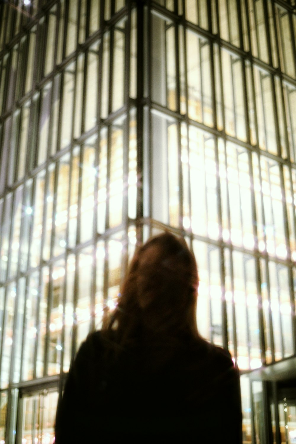 a woman standing in front of a tall building