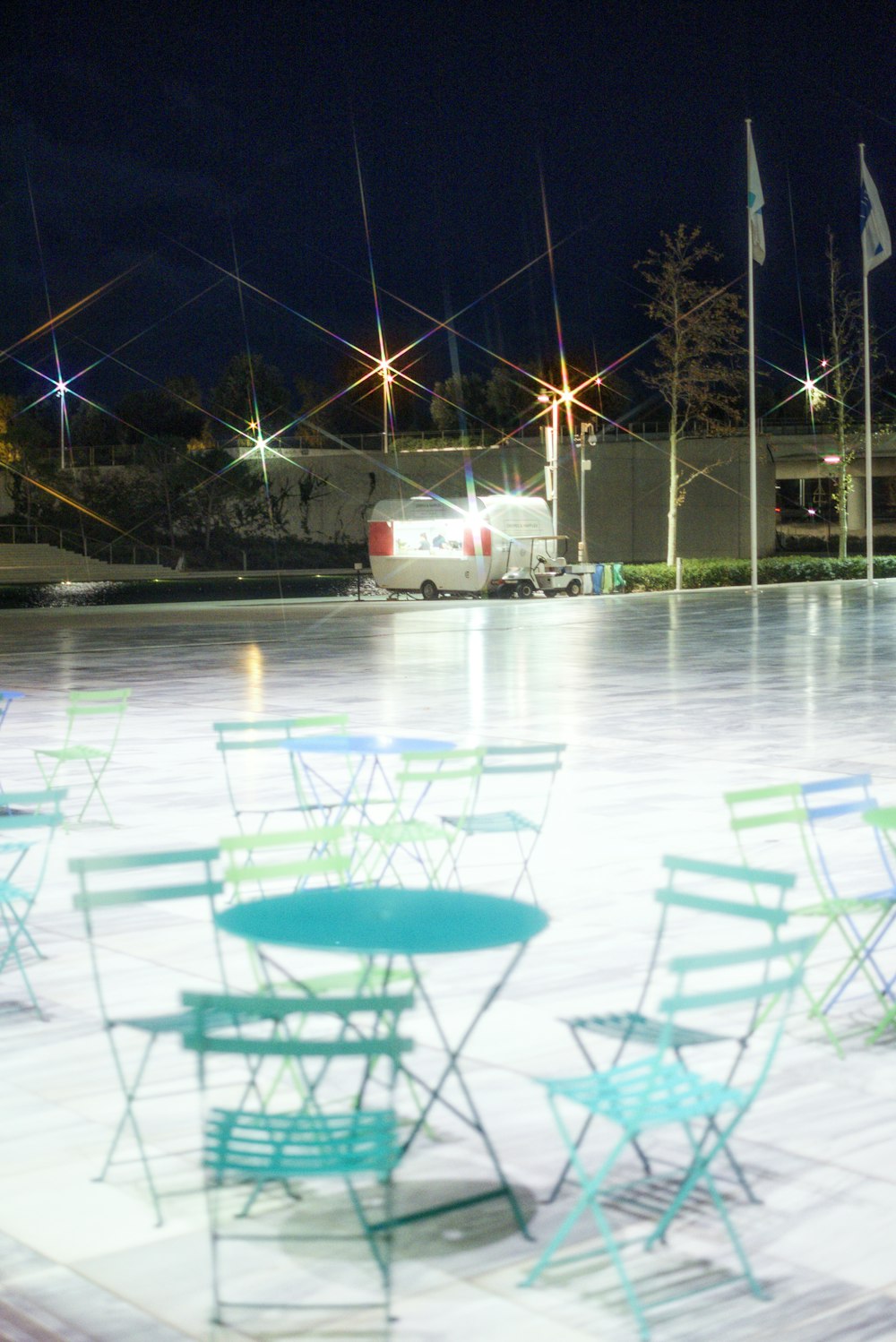 a group of chairs and tables sitting on top of a ice rink