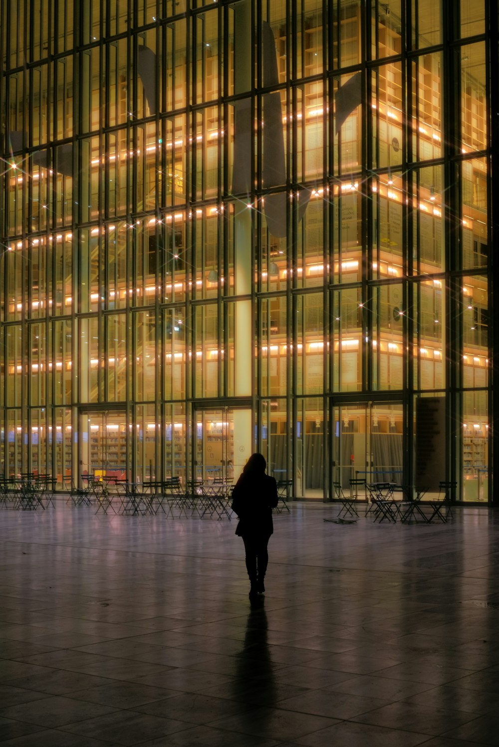 a person walking in front of a large building