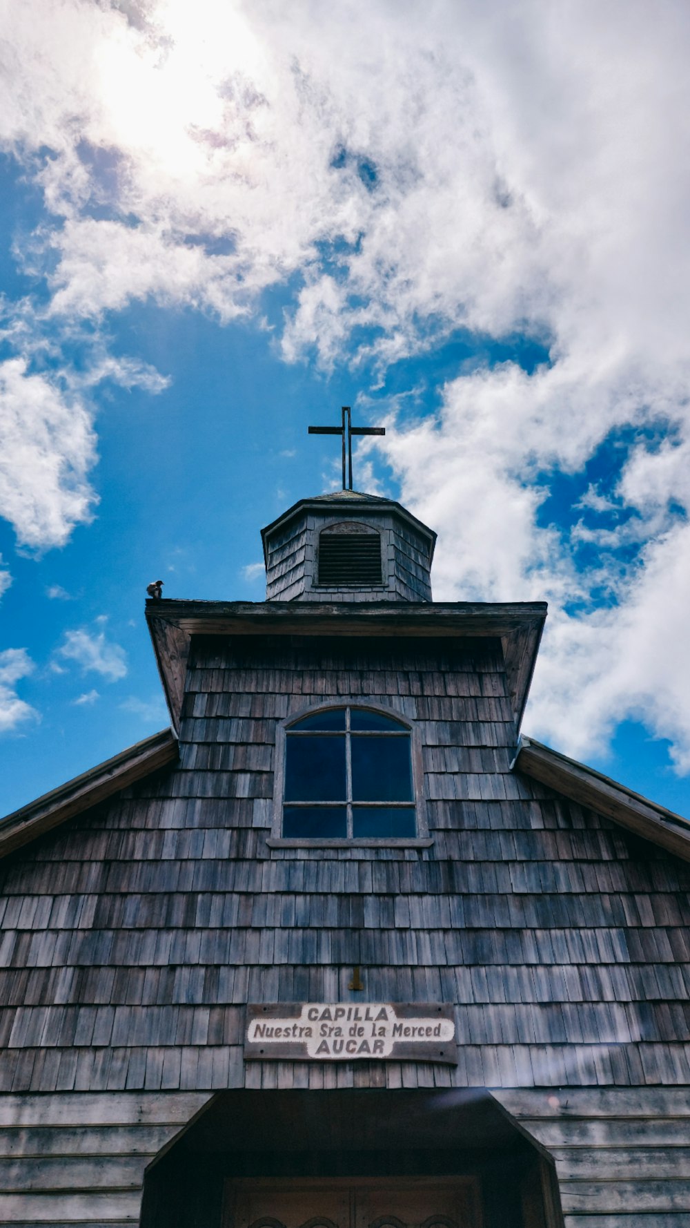 a church with a steeple and a cross on top