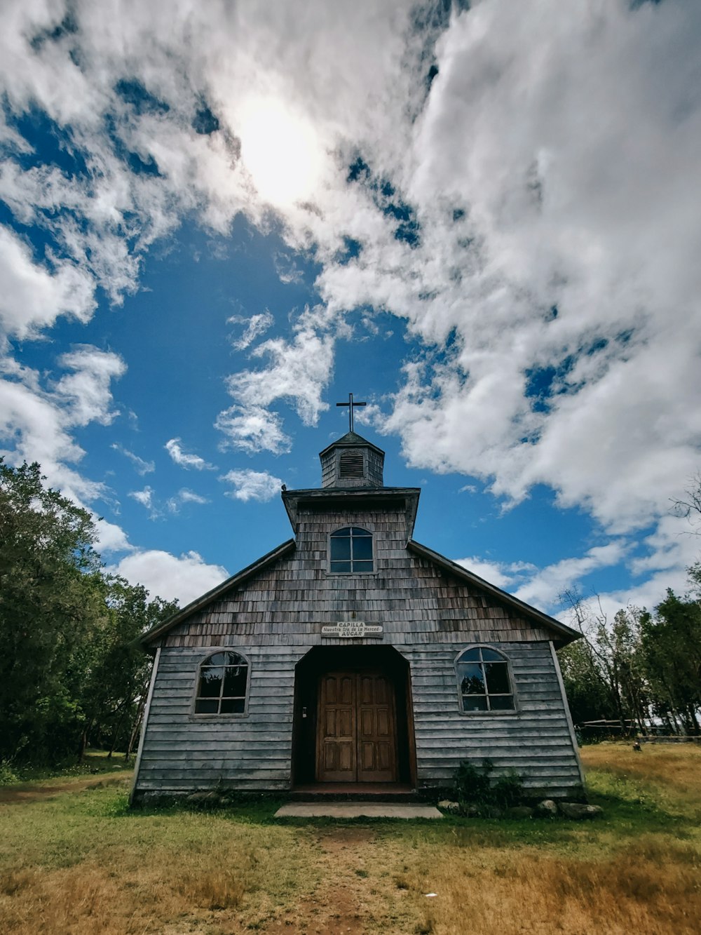 a church with a steeple and a cross on top