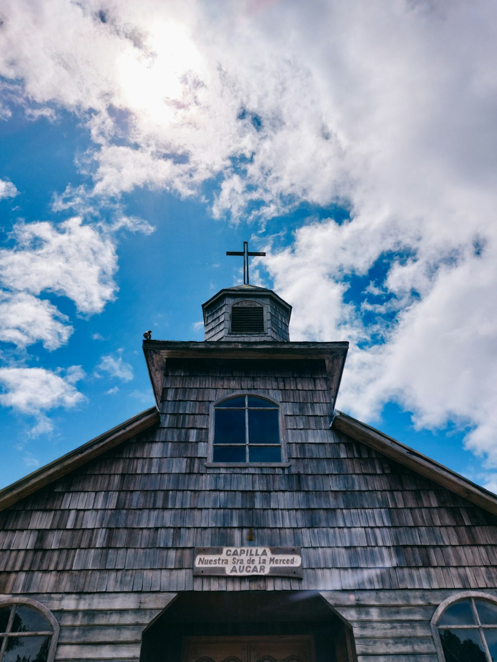 a church with a steeple and a cross on top