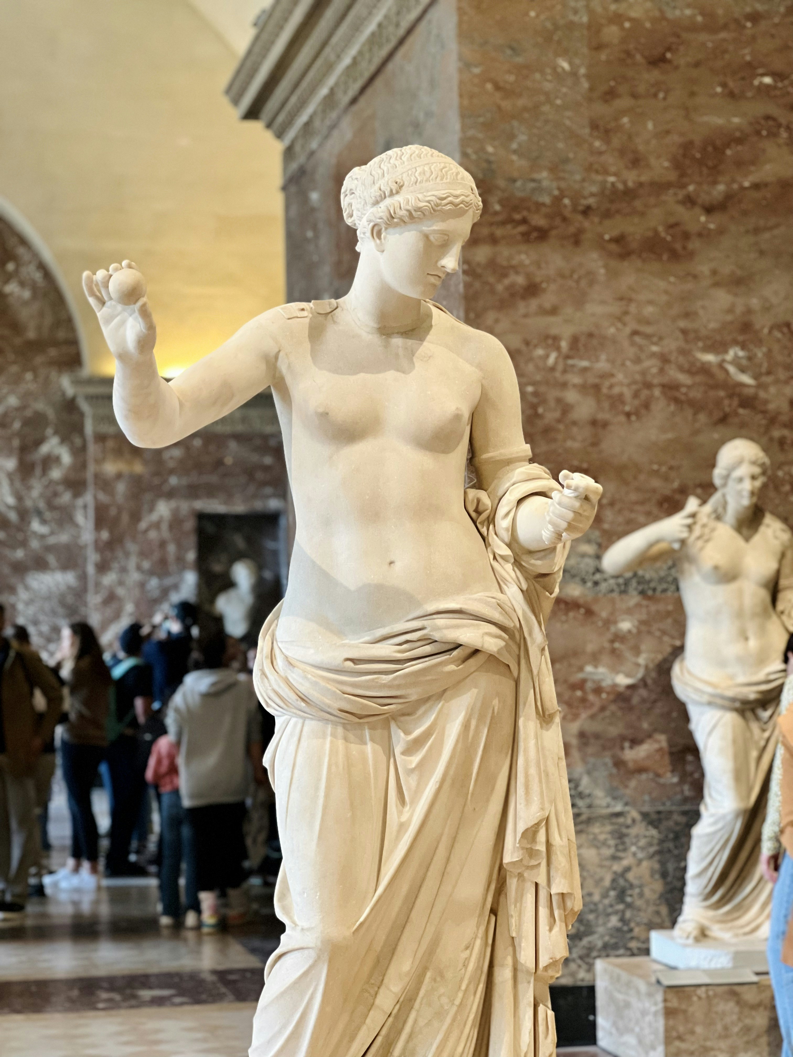 A marble statue of Aphrodite in a museum.