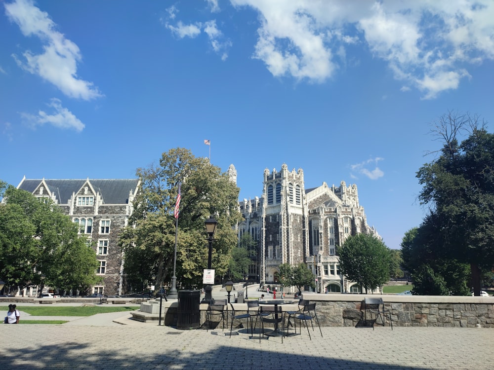 a large building with a clock tower in the middle of a park