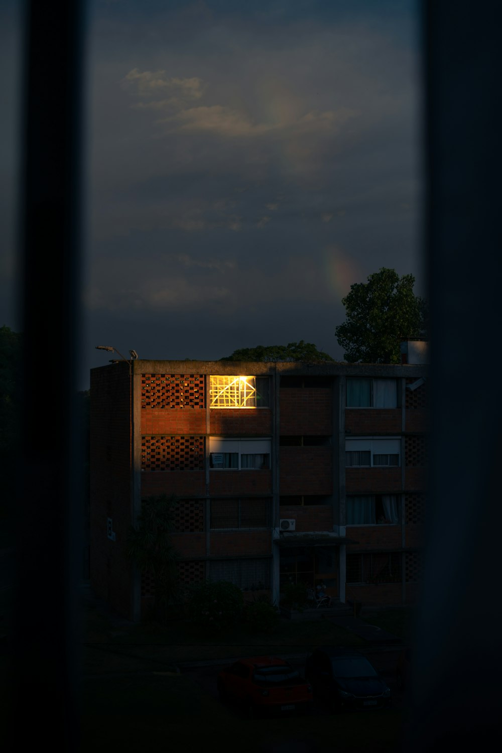 a view of a building through a window at night