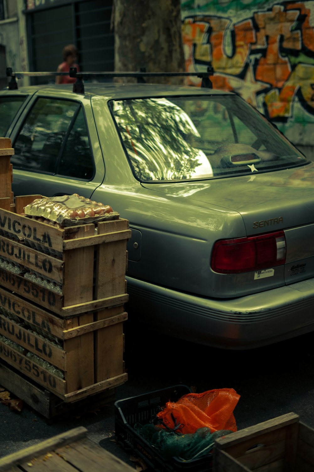 a car parked next to a pile of crates