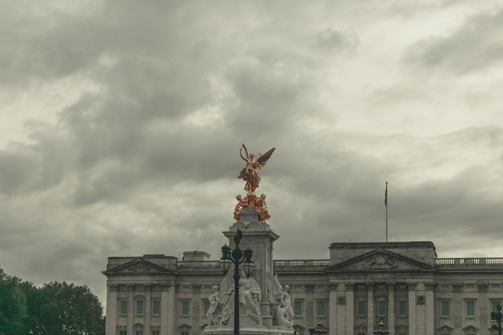 a large building with a statue on top of it