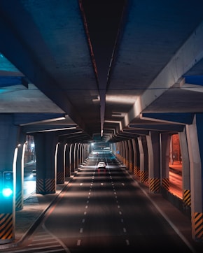 a long tunnel with a car going through it