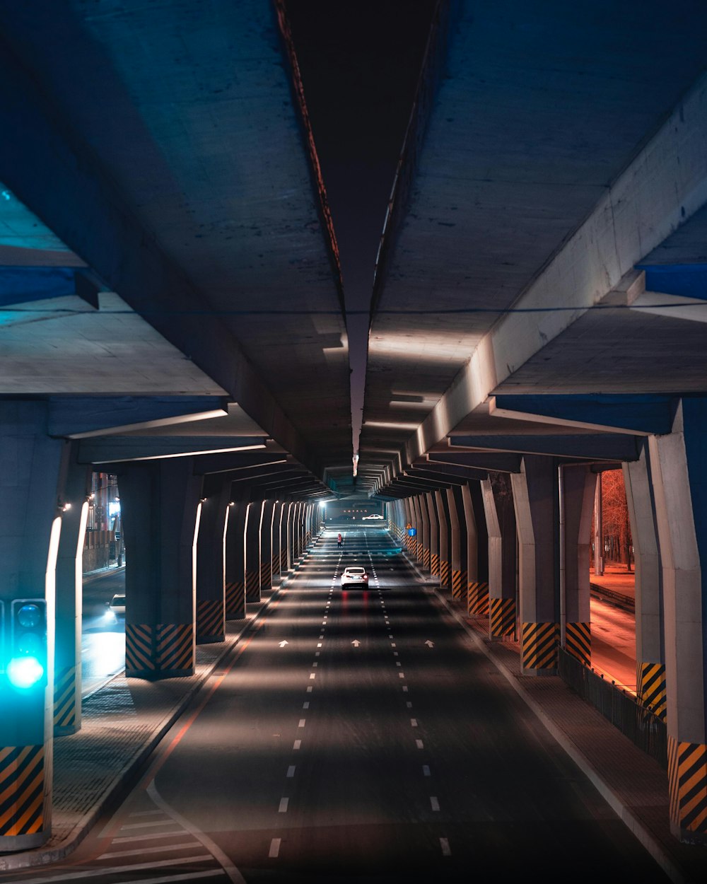 a long tunnel with a car going through it