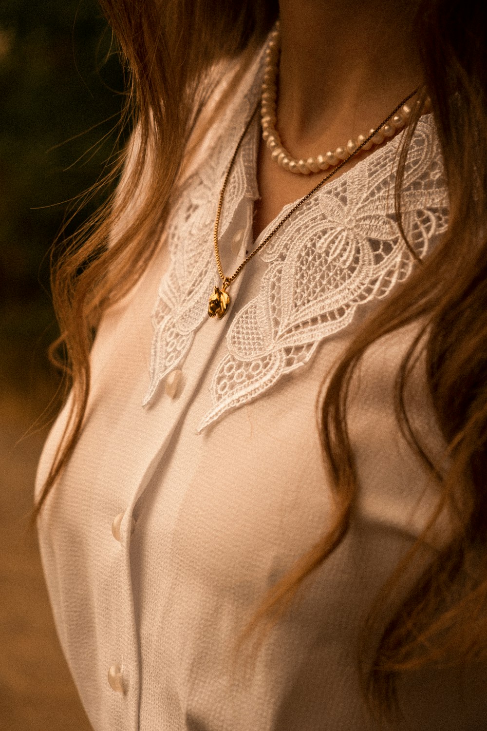 a close up of a woman wearing a necklace