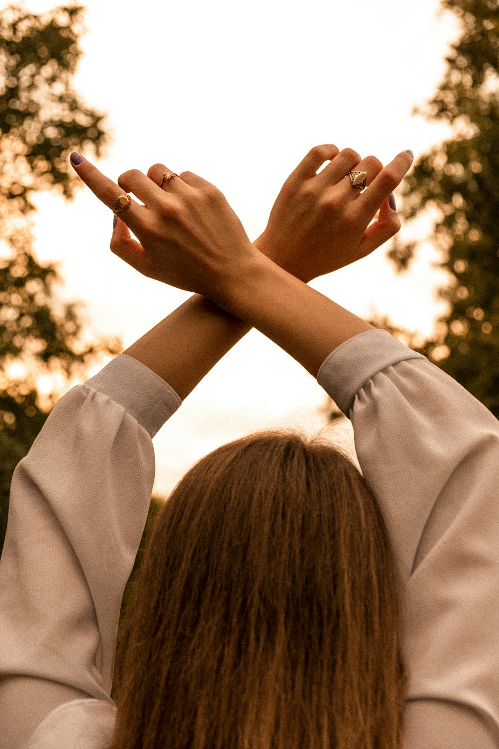 a woman is holding her hands up in the air