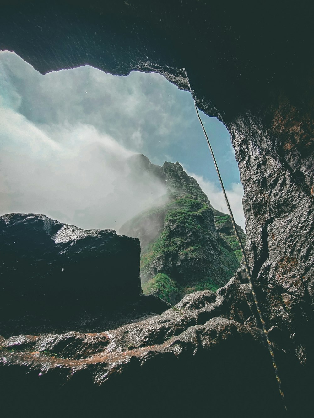 a view of a mountain from inside a cave