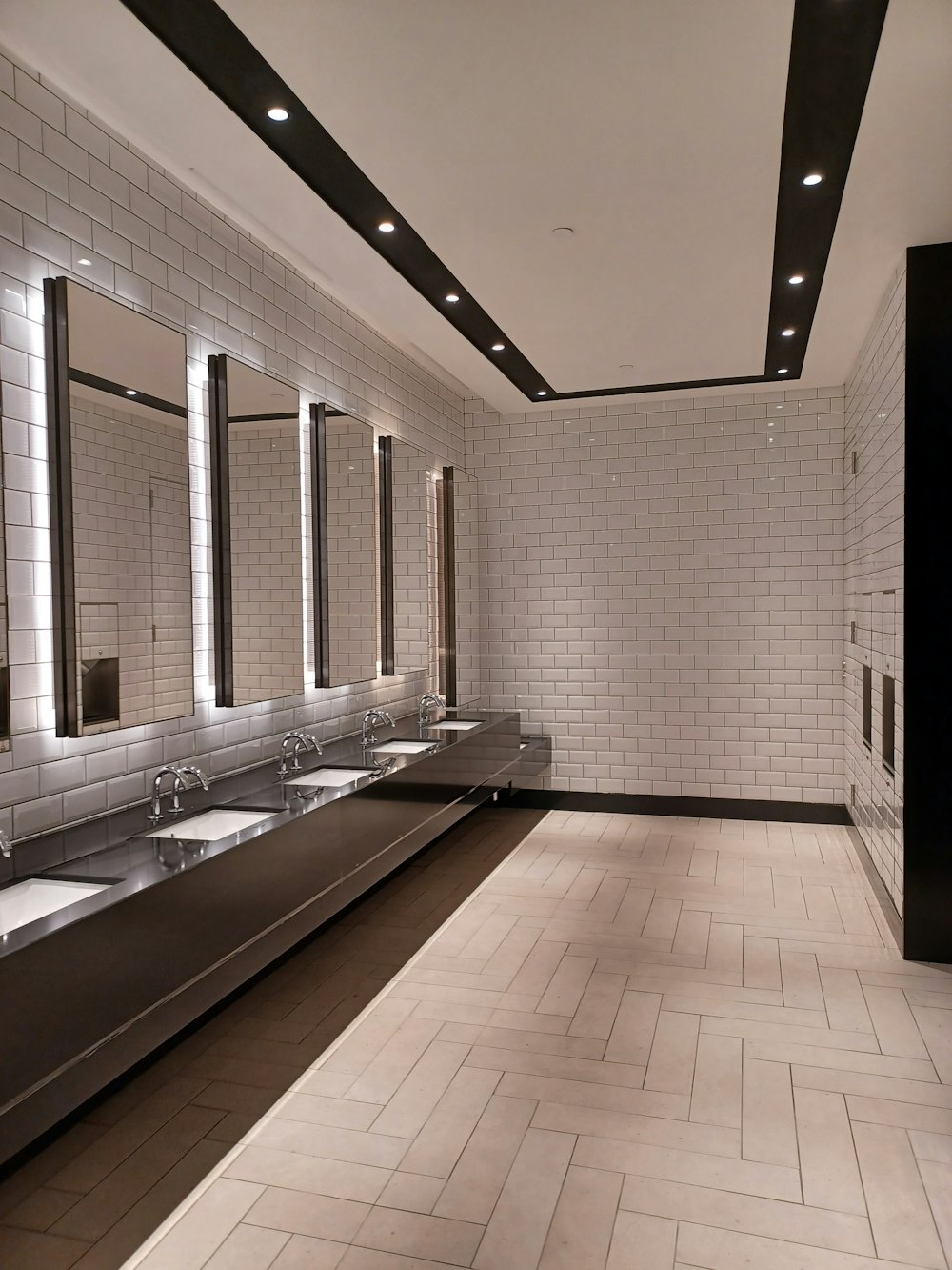 a public restroom with sinks and mirrors