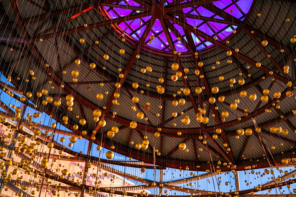 a ceiling filled with lots of hanging oranges