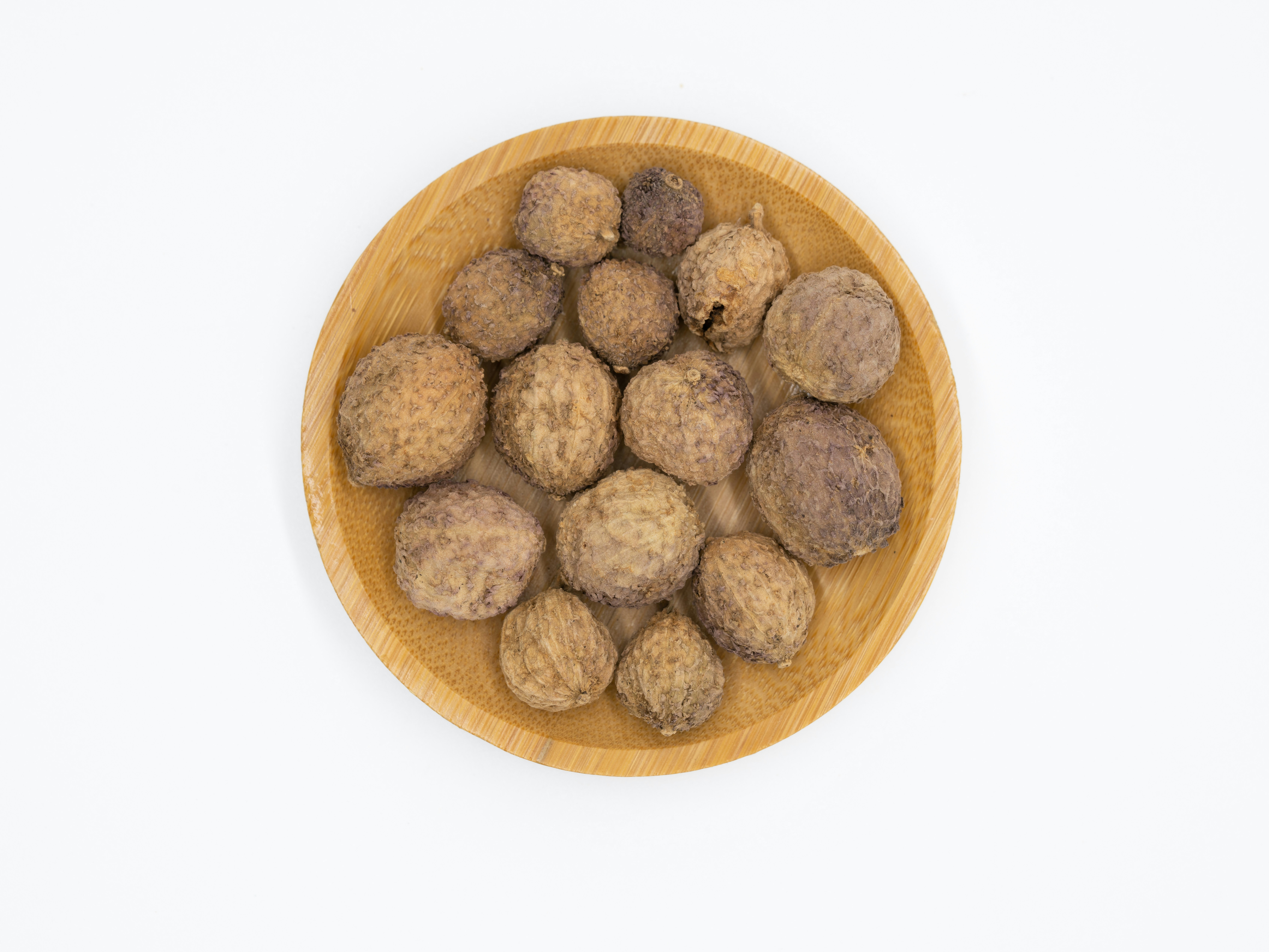 Dried caraway seeds in a small ceramic bowl on natural linen surface