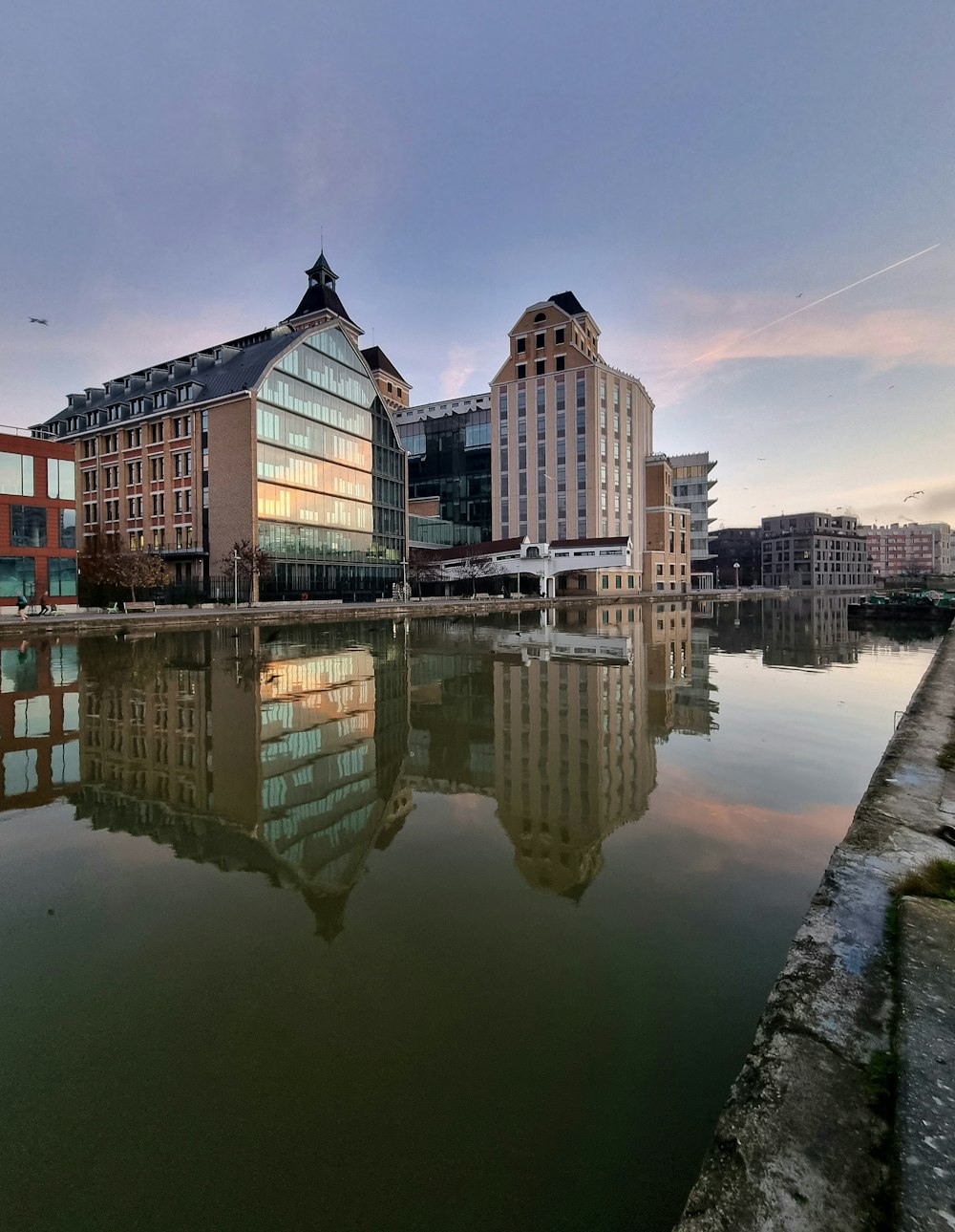 a body of water with buildings in the background