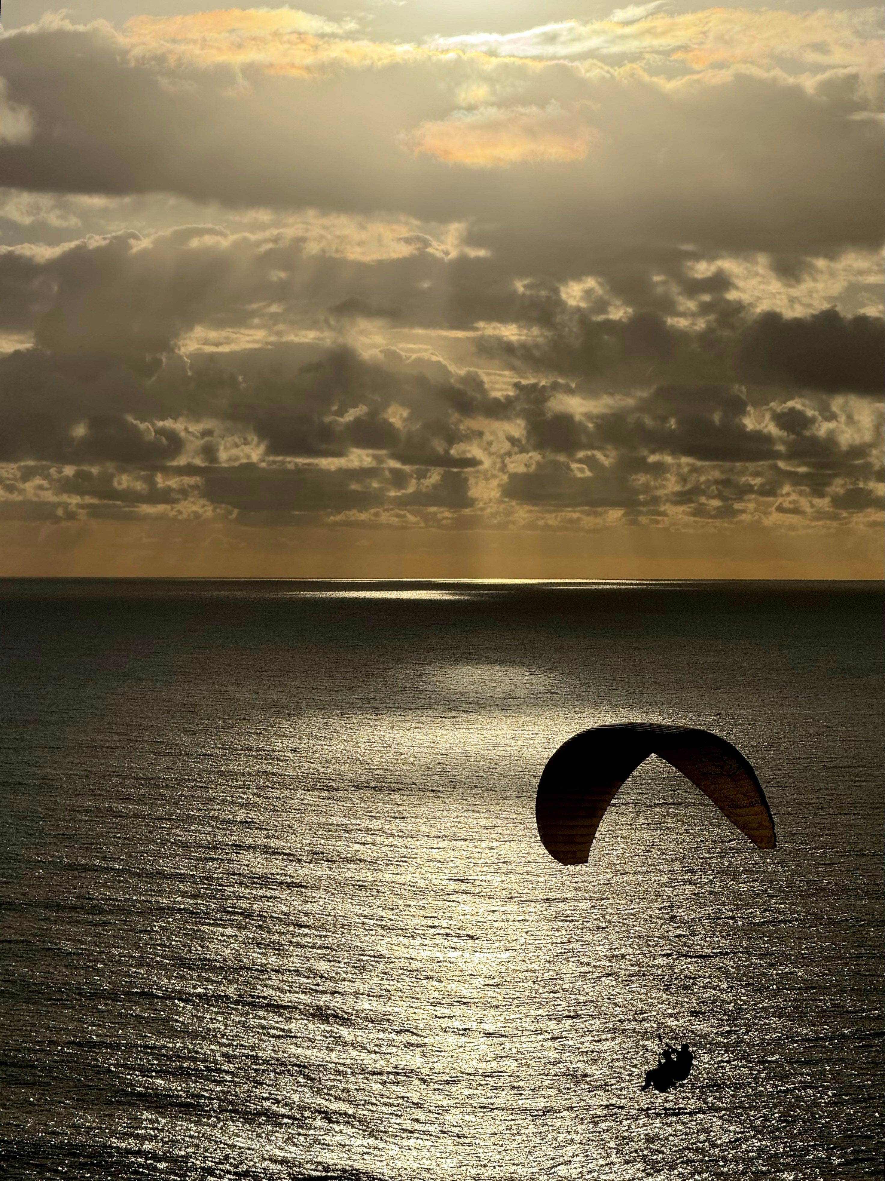 a parasailer in the middle of a large body of water