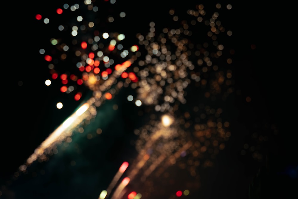 a blurry photo of fireworks in the night sky