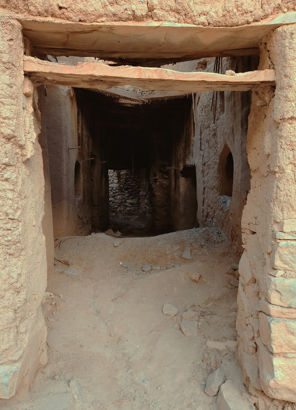 a stone building with a doorway in the middle of it