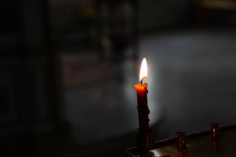 a lit candle sitting on top of a table