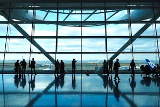 a group of people standing in front of a window