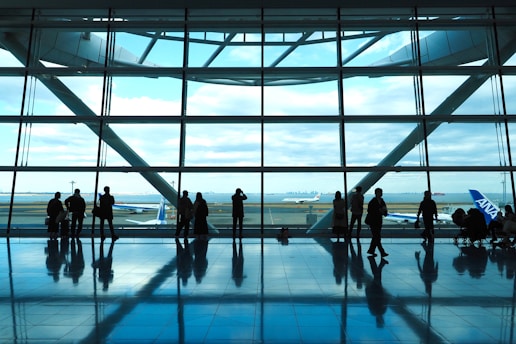 a group of people standing in front of a window