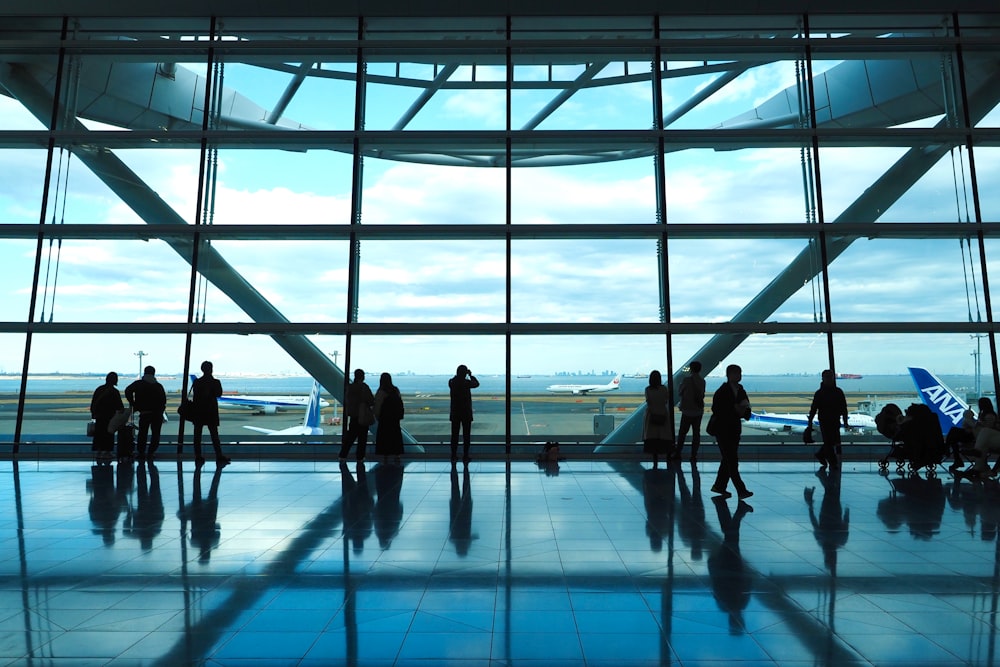 a group of people standing in front of a window