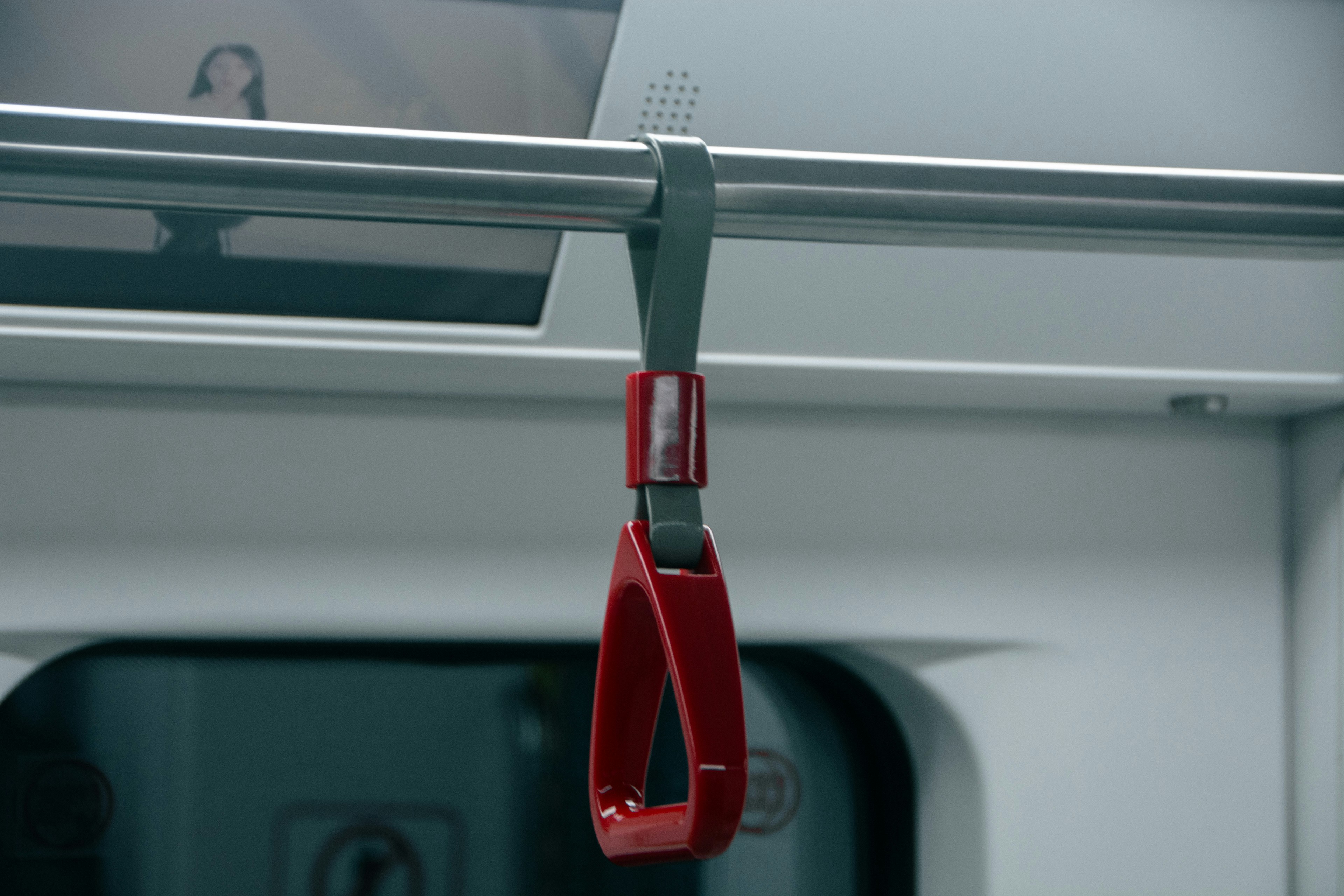 a red pair of scissors hanging from a rail
