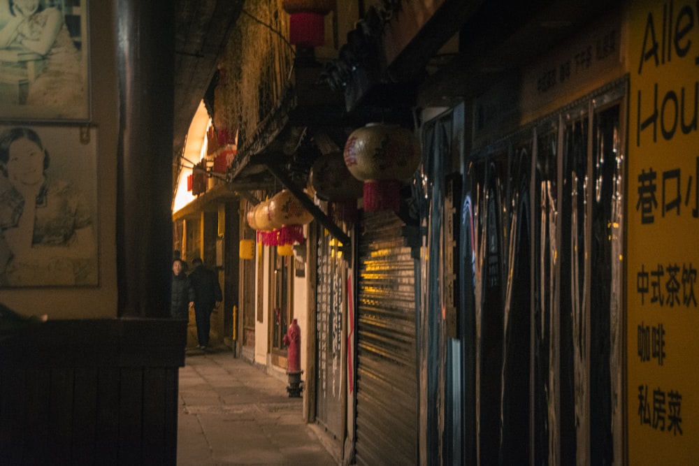 a narrow alley way with lots of shops