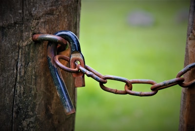 a close up of a chain attached to a wooden post