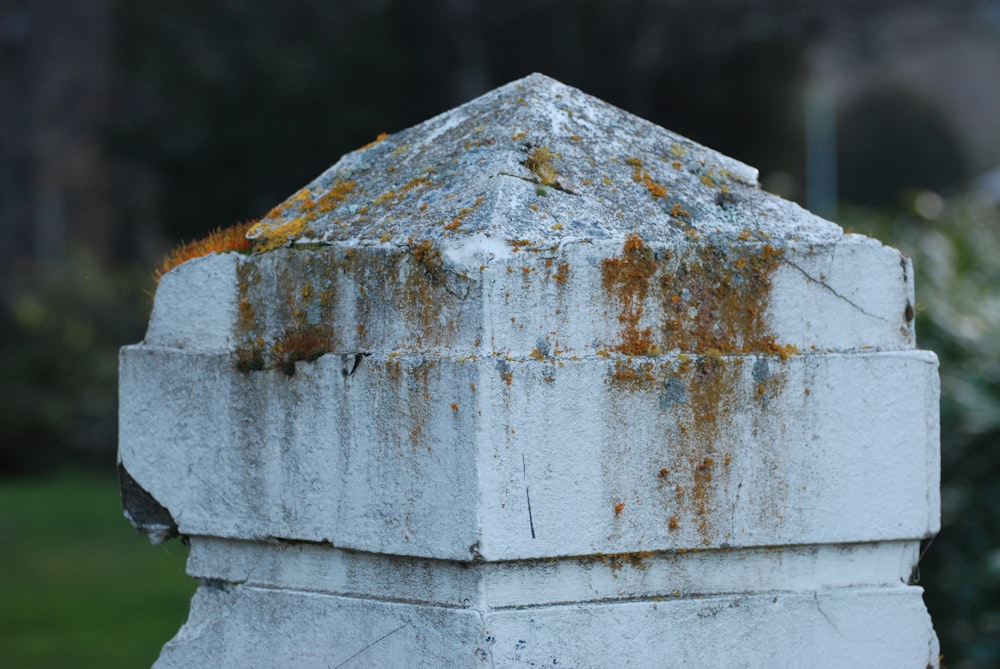 a close up of a cement structure with rust on it