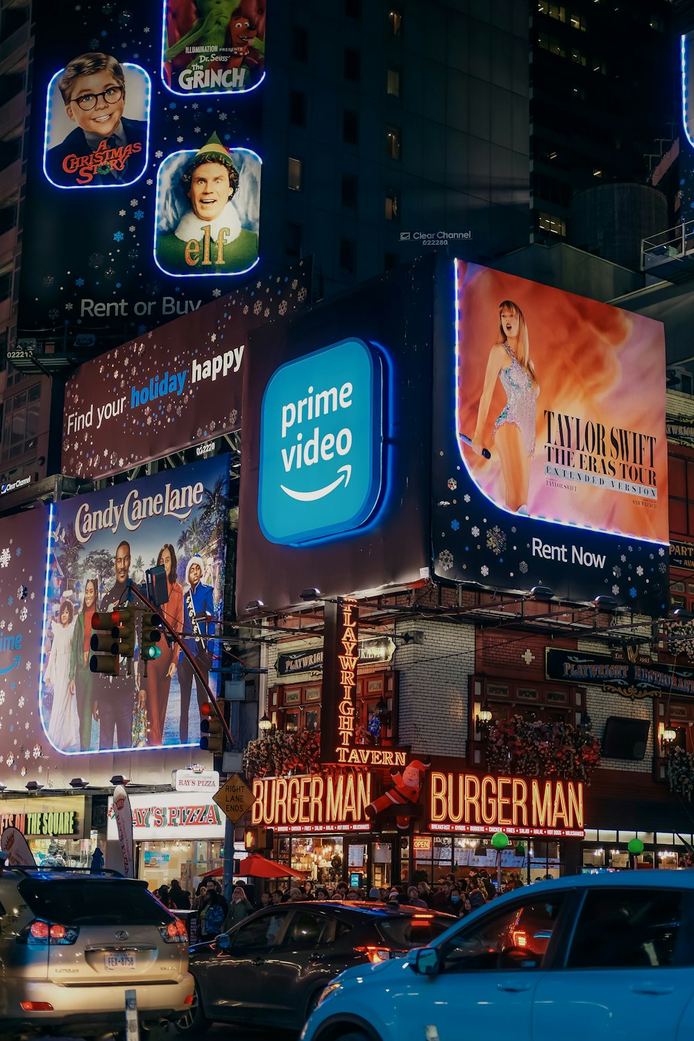 a busy city street filled with lots of billboards