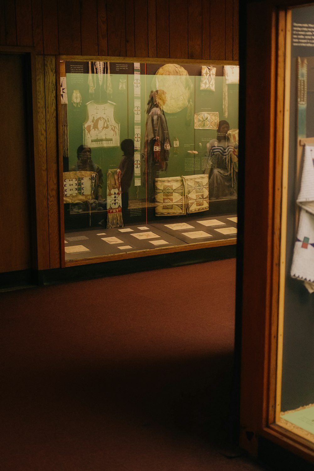 a store window with a reflection of a person in it