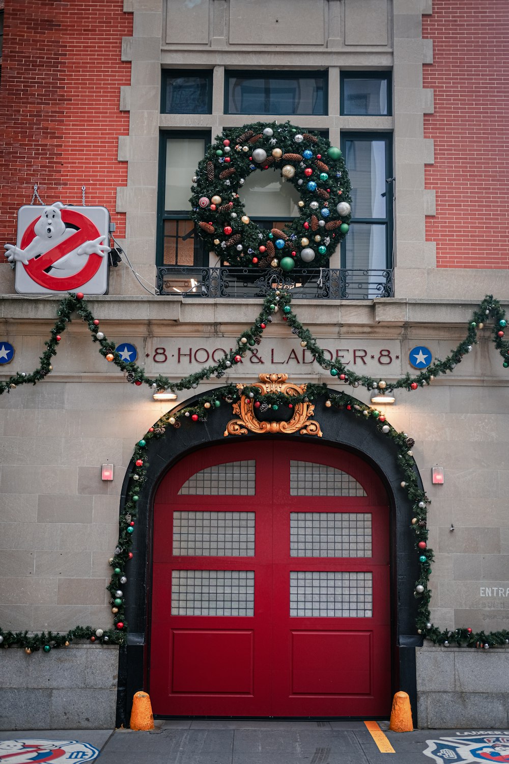 a red door with a wreath on top of it