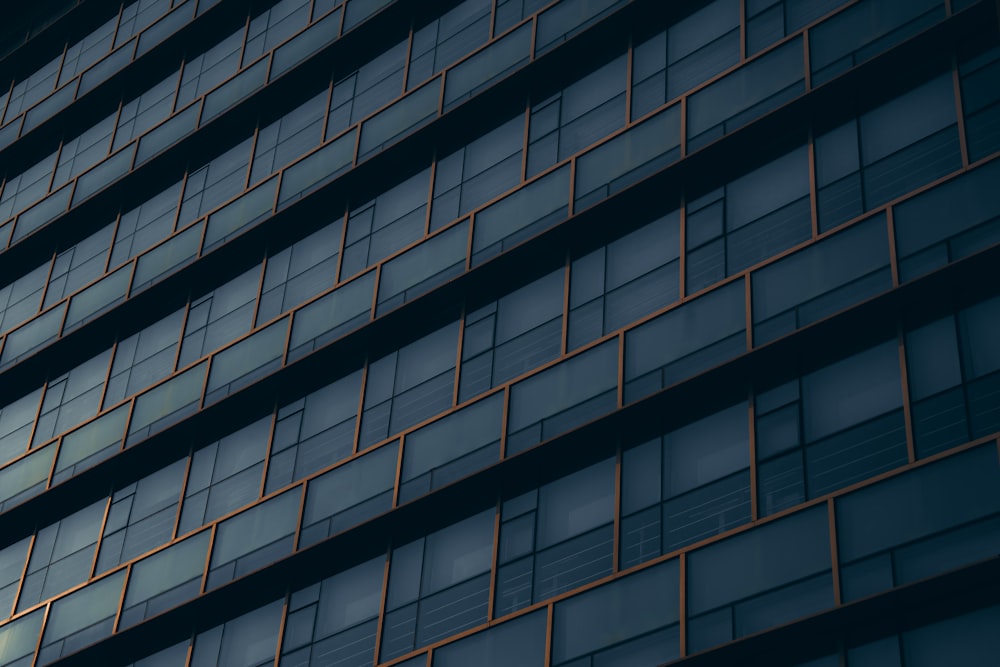 a tall building with lots of windows next to a street light