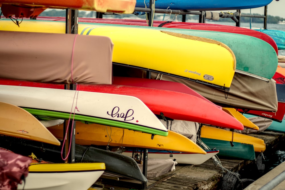 a row of canoes sitting on top of a wooden dock