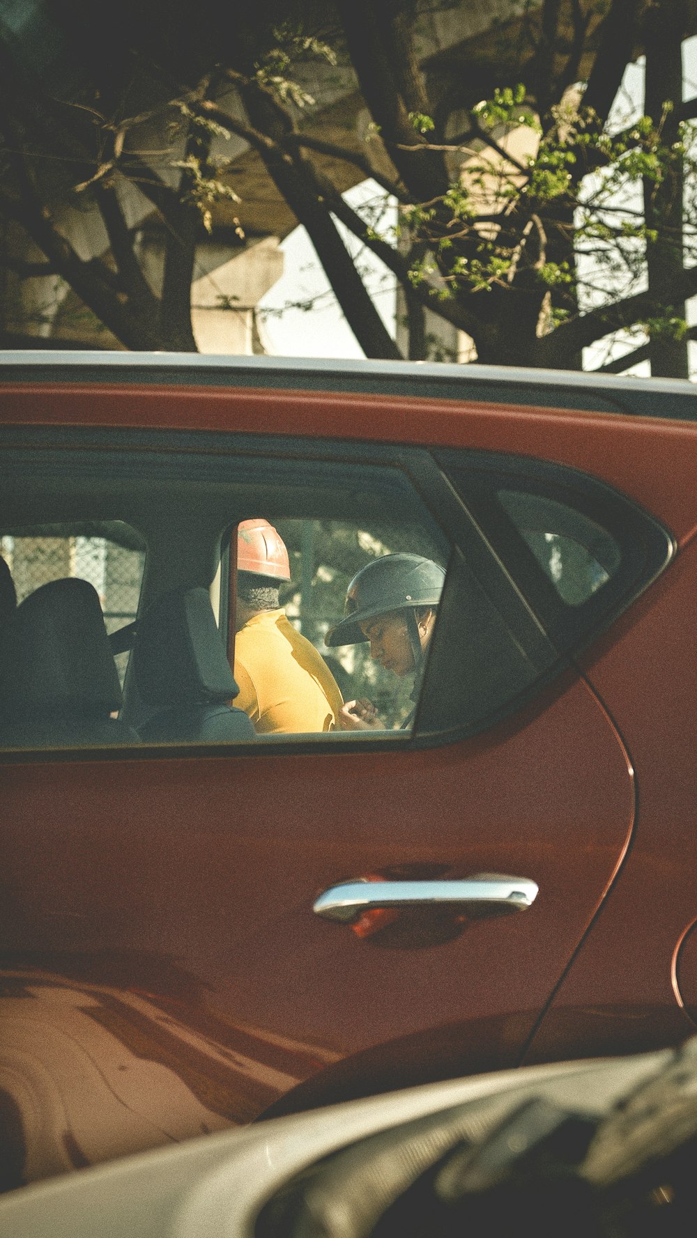 a red car with a banana in the passenger seat